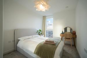 豪士罗Sunset Retreat: Steps from Heathrow/Twickenham的一间带床和窗户的白色卧室