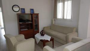 a living room with two couches and a tv at Kastoria apartment μπροστά στη λίμνη στο κέντρο in Kastoria