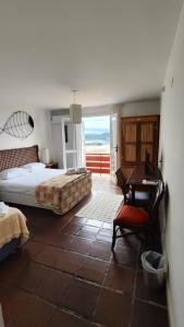 a bedroom with a bed and a desk and a table at Hotel Camboa Antonina - PR in Antonina +89 photos