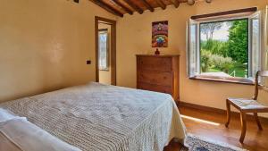 a bedroom with a bed and a window and a dresser at Casa Rocchi in Capannori +37 photos
