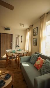 a living room with a couch and a table at Seahorse apartment in Liepāja