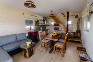 a living room with a blue couch and a table at WeinSpitz - Wellness House in Miklavž pri Ormožu