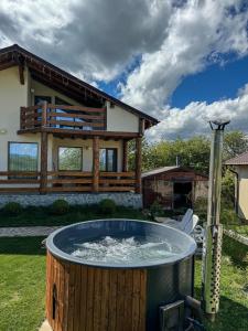 a hot tub in the yard of a house at Green Hill Resort in Zărneşti