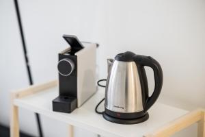 a tea kettle and a speaker on a table at Airguest Pianella Rooms in Milan