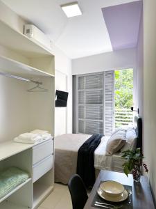 a small bedroom with a bed and a window at CoVivere - RJ in Rio de Janeiro