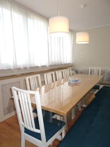 a dining room with a wooden table and chairs at Smart Apartament Premium Tei - 110 mp, 4 Camere, Jacuzzi & Living Generos, Cameră Copii, Piatra Neamț in Piatra Neamţ +45 photos