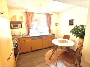 a small kitchen with a table and a sink at Franziskaner Suites #12 in Graz