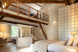 a bedroom with a large bed and a staircase at Château Les Oliviers de Salettes in Charols