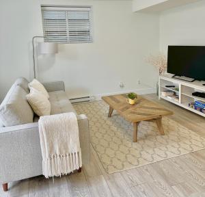 a living room with a couch and a coffee table at Homelike & cozy suite in Langley