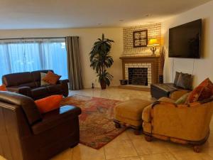 a living room with furniture and a fireplace at Spacious House in Fort Lauderdale - Minutes from Beach in Fort Lauderdale