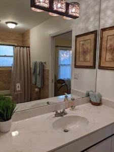 a bathroom with a sink and a large mirror at Spacious House in Fort Lauderdale - Minutes from Beach in Fort Lauderdale +10 photos