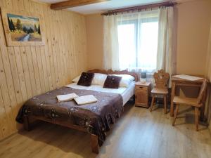 a bedroom with a bed with two towels on it at Pokoje gościnne Jawor in Bukowina Tatrzańska