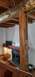 a wooden table with a stove in a room at Casa Ines in Ricobayo