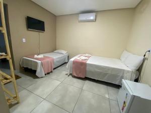Cama ou camas em um quarto em Pousada Vista da Serra - Suzart