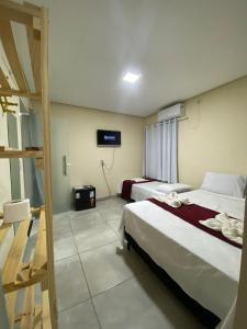 Cama ou camas em um quarto em Pousada Vista da Serra - Suzart