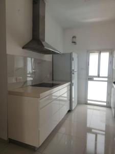 a kitchen with white cabinets and a stove top oven at Dream house! in Qiryat Bialik