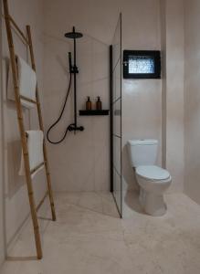 a bathroom with a toilet and a ladder at Kynthia Hotel - Adults Only in Kalogria