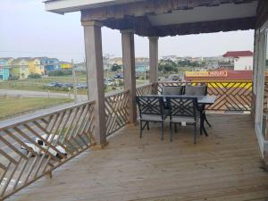 una terraza de madera con mesa y sillas. en 6812 Beach Rd, Semi Oceanfront, Pool, Hot Tub en Nags Head