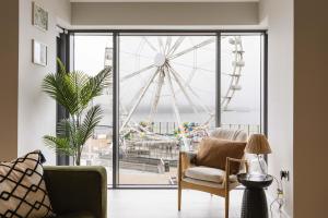 a living room with a view of a ferris wheel at DB Stays in Portrush