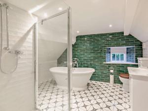 a bathroom with a shower and a tub and a toilet at 2 Bed in Alnwick 93093 in Edlingham