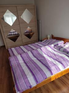 a bed with a wooden headboard with three boxes on it at Privat ZUZANA in Prosiek