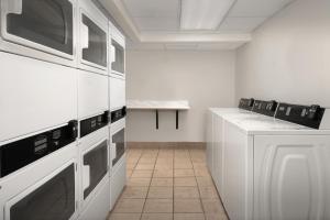 a kitchen with white cabinets and a counter top at Residence Inn Palo Alto Los Altos in Palo Alto