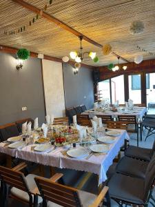 a large dining room with long tables and chairs at Morrison Rezidence in Miercurea-Ciuc