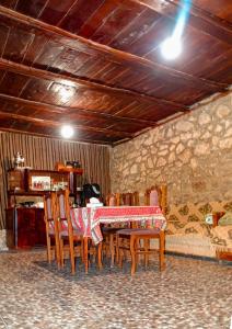a dining room with a table and some chairs at Aspet B&B in Tatʼev