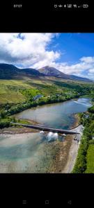 an aerial view of a river with mountains in the background at Pier Road Cottage, Croagh Patrick in Westport