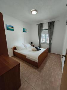 Llit o llits en una habitació de Apartmani Barešić
