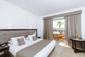 a hotel room with a large bed and a balcony at Akassia Swiss Resort in Quseir