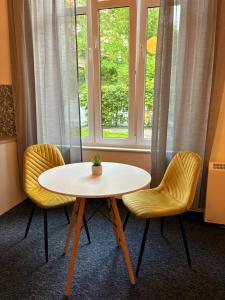Una mesa y dos sillas frente a una ventana. en Panama - Sopot Centrum, en Sopot