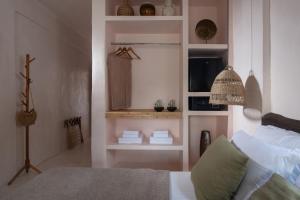 a living room with a bed and a microwave at Kynthia Hotel - Adults Only in Kalogria