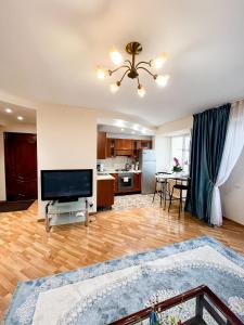 a large living room with a flat screen tv at Золотой квадрат 60 кв2 in Almaty