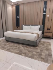 een slaapkamer met een groot bed met witte kussens bij Elite House in Taif