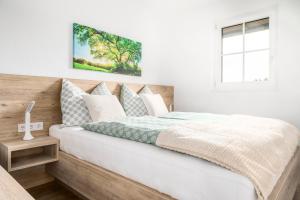 a bedroom with a bed with a wooden headboard at Miglurahof in Adnet