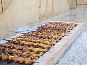 a group of chickens are being cooked on a grill at Desert Safari Dubai Over Night Stay in Hunaywah
