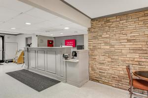 eine Lobby mit einer Backsteinmauer und einer Kasse in der Unterkunft Red Roof Inn Kingsport in Kingsport