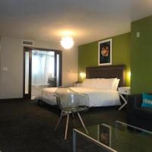 a bedroom with a bed and a green wall at Congress Ocean Drive in Miami Beach