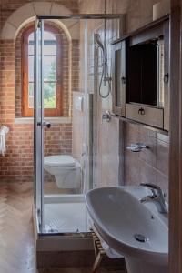 a bathroom with a glass shower and a sink at B & B Torre Saracena in Mattinata