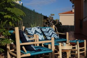 a pair of chairs and a couch on a patio at Casa Golden in Caleta De Fuste