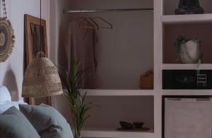 a room with a shelf with a lamp and a plant at Kynthia Hotel - Adults Only in Kalogria