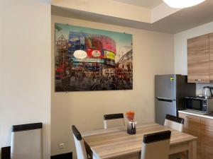 una cocina con una mesa y una pintura en la pared en Chavchavdze VAKE - 1BR Apartment, en Tiflis