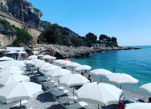 a group of white umbrellas on a beach at La Dolce Vista in Dolceacqua