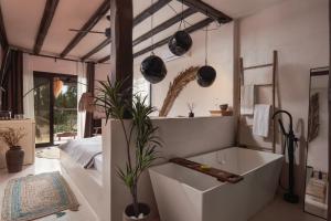 a bathroom with a bath tub in a room at Kynthia Hotel - Adults Only in Kalogria
