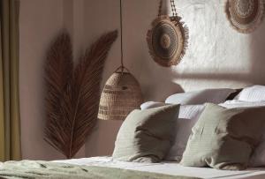 a bedroom with a bed with white sheets and pillows at Kynthia Hotel - Adults Only in Kalogria