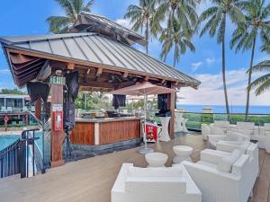 a bar with white couches in front of a pool at Beach Resort condo 921 in Miami Beach