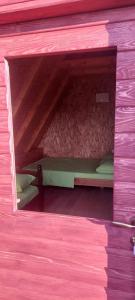 a small pink room with a bunk bed in it at Etno selo Šapat in Šavnik