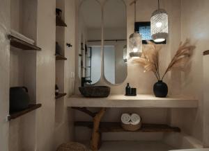 a bathroom with a sink and a mirror at Kynthia Hotel - Adults Only in Kalogria