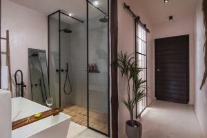 a shower with a glass door in a bathroom at Kynthia Hotel - Adults Only in Kalogria